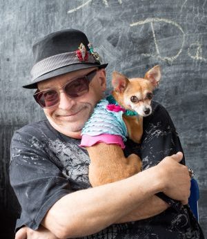 Photo of Juan Pablo Gutiérrez holding his small dog Malena
