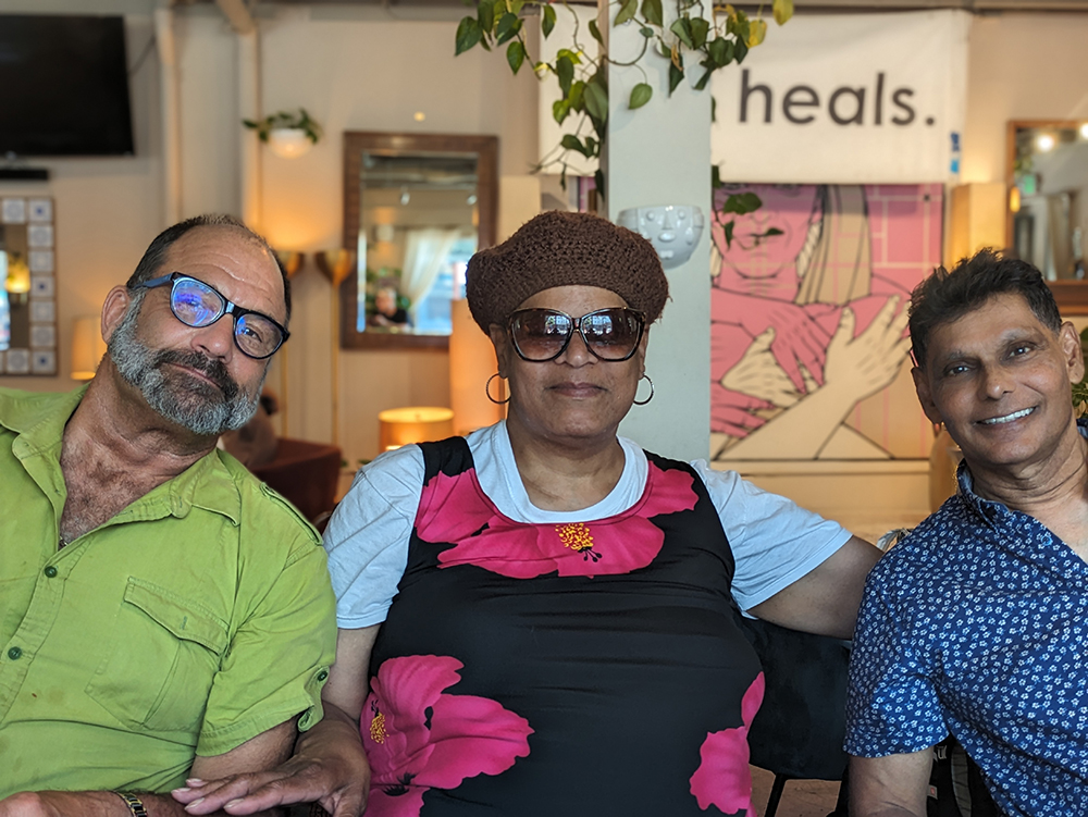 Three Meals Heal participants sitting together, looking at the camera.